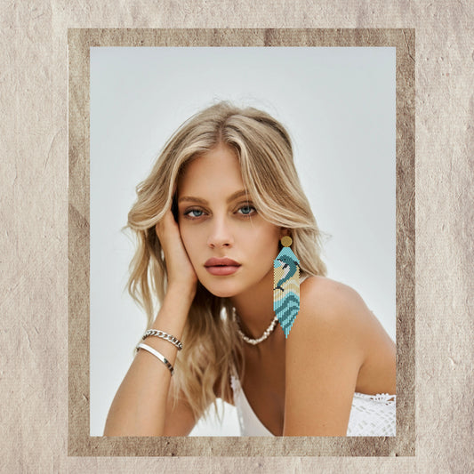 Woman wearing dolphin earrings with a neutral background