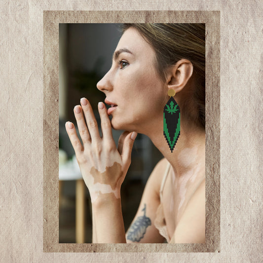 Woman wearing marijuana green earring with a textured beige border