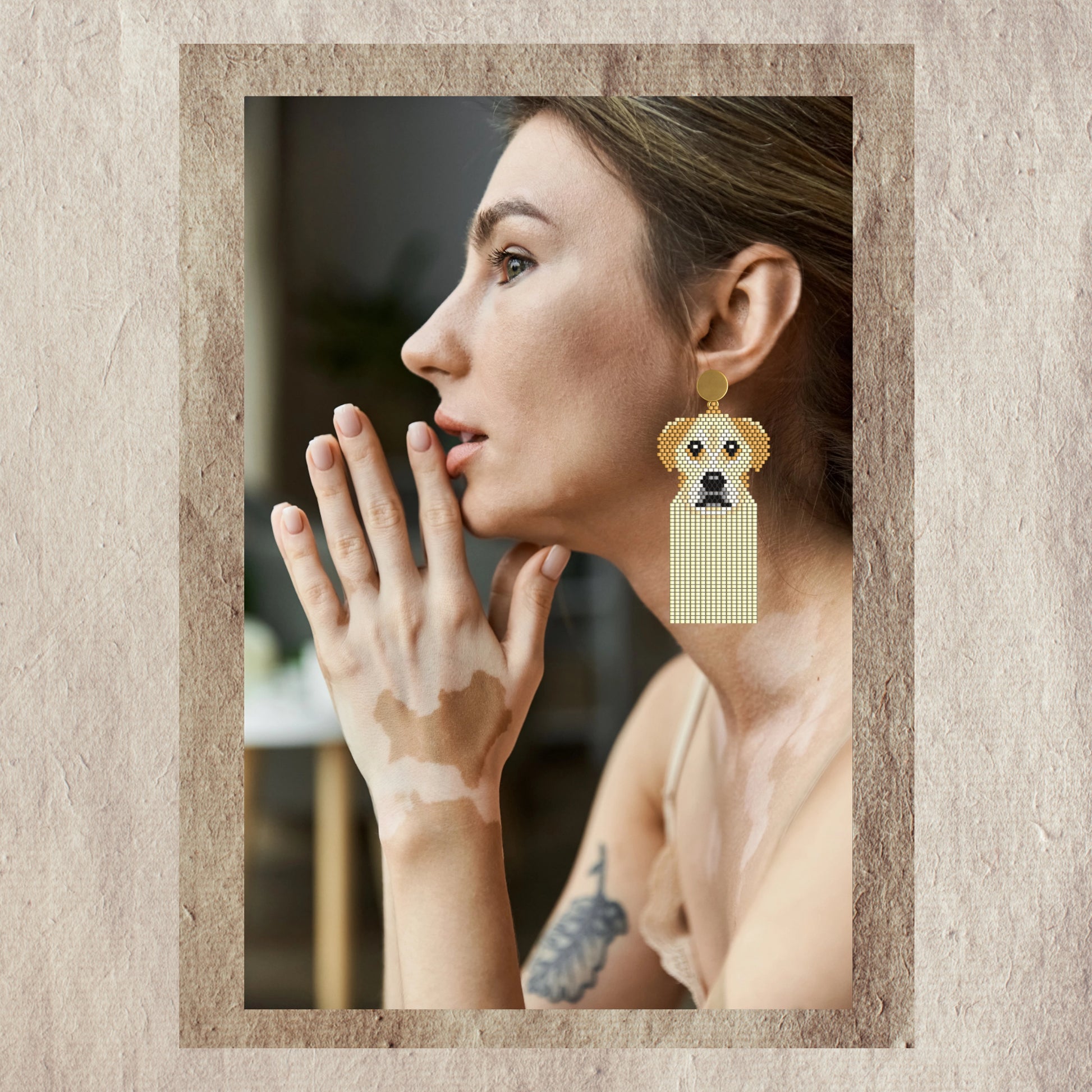 Woman wearing dog-shaped earrings with a neutral background