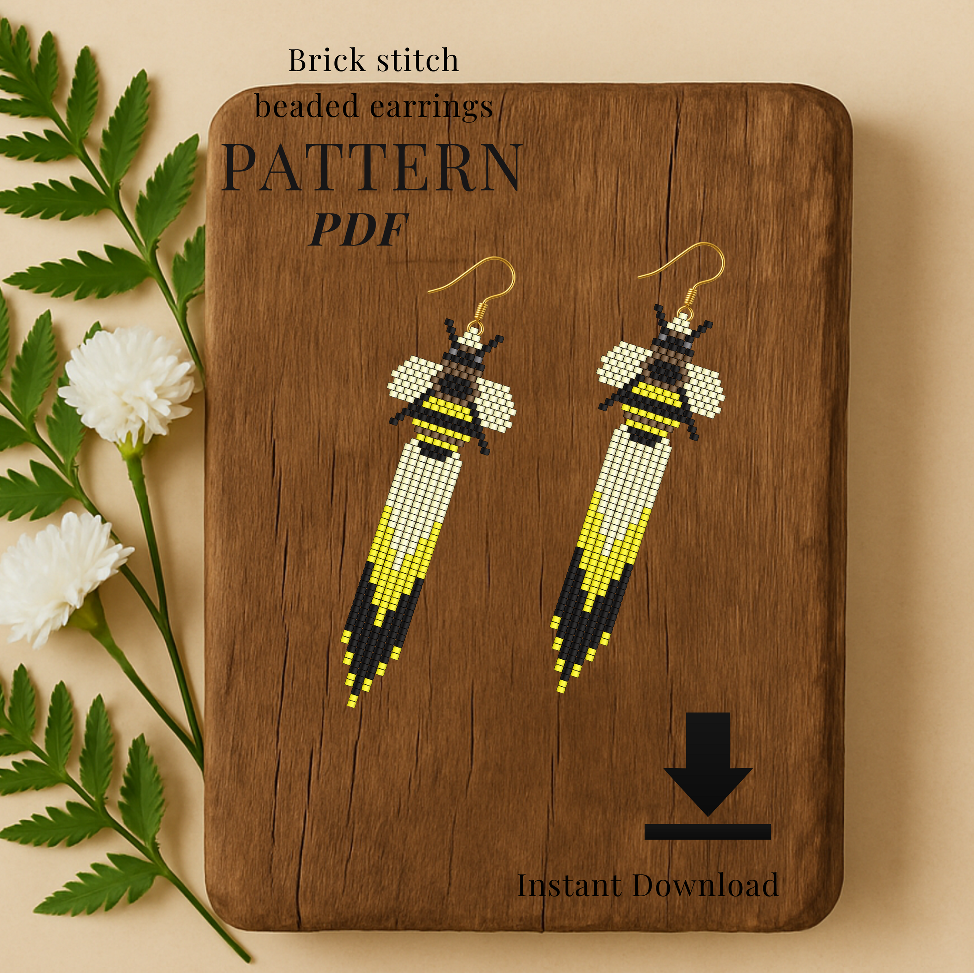 Bee Brick stitch beaded earrings on a wooden board with floral elements.