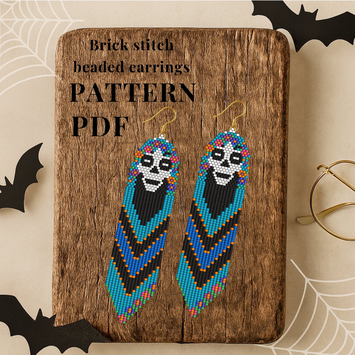 Skull Brick stitch beaded earrings pattern PDF on a wooden board with Halloween decorations.