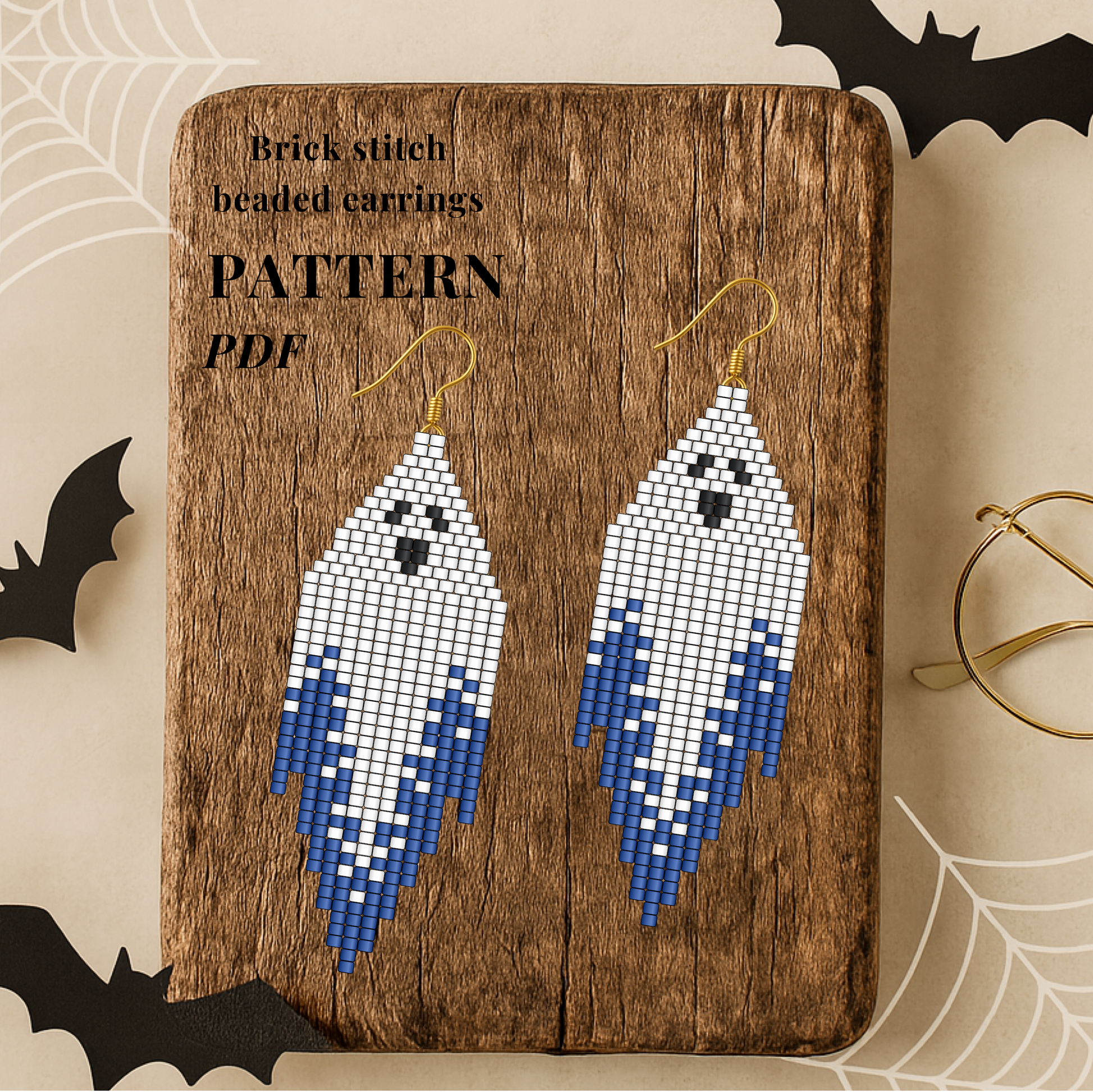 Halloween Brick stitch beaded earrings on a wooden board with Halloween decorations.