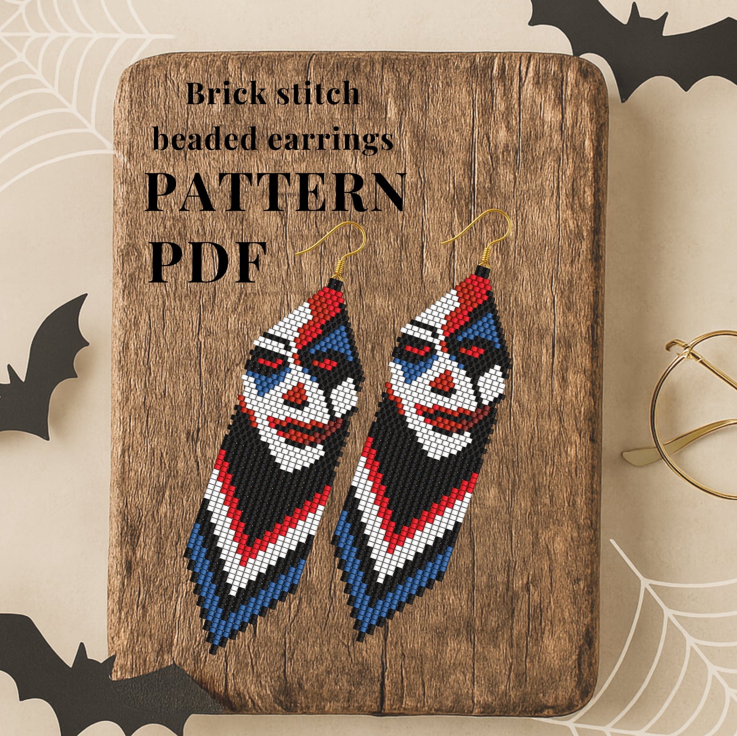 Brick stitch beaded earrings on a wooden board with Halloween-themed decorations.