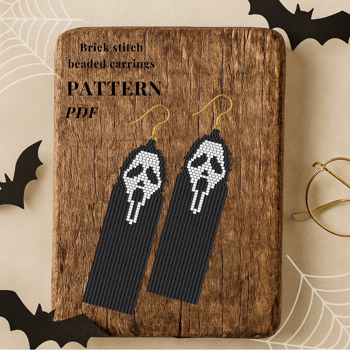 Brick stitch beaded earrings on a wooden board with 'Pattern PDF' text, surrounded by Halloween decorations.