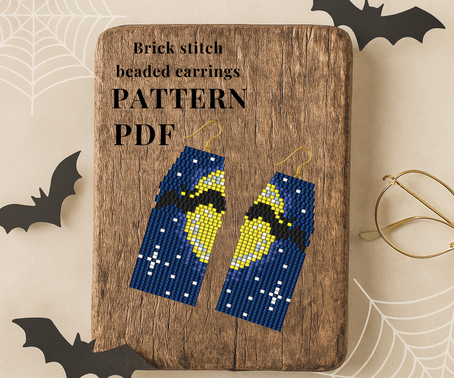 Bat Brick stitch beaded earrings on a wooden board with 'Pattern PDF' text, surrounded by Halloween decorations.