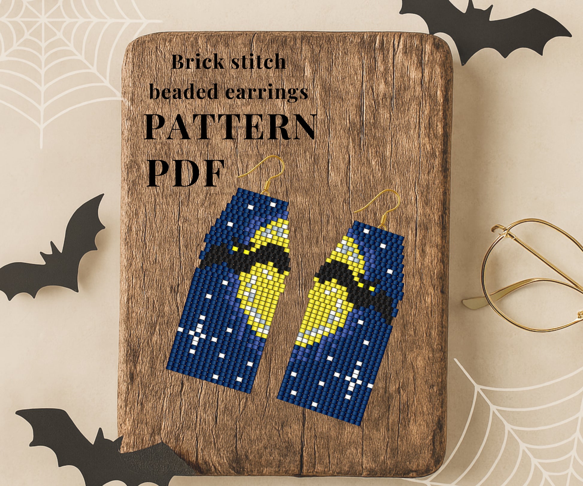 Bat Brick stitch beaded earrings on a wooden board with 'Pattern PDF' text, surrounded by Halloween decorations.