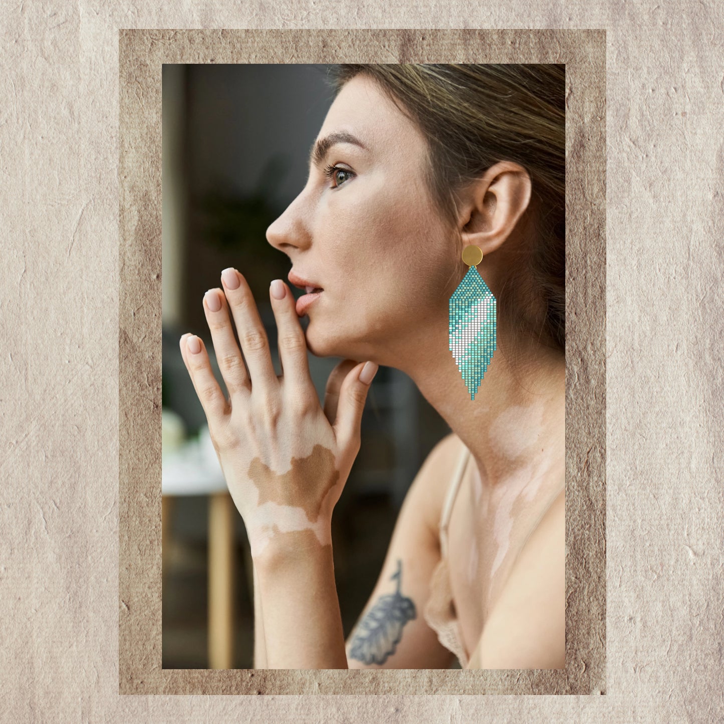 Woman wearing turquoise abstract earrings
