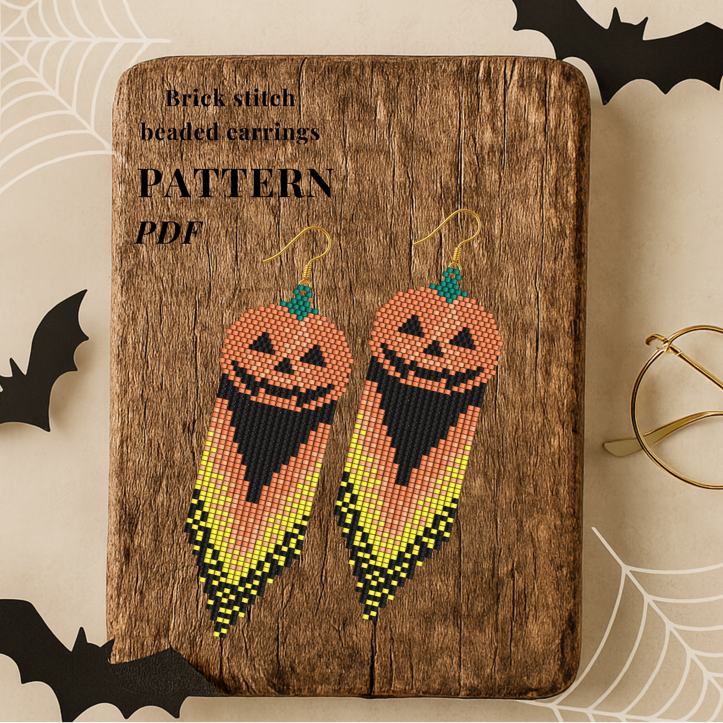 Brick stitch beaded earrings pattern PDF on a wooden board with Halloween decorations.