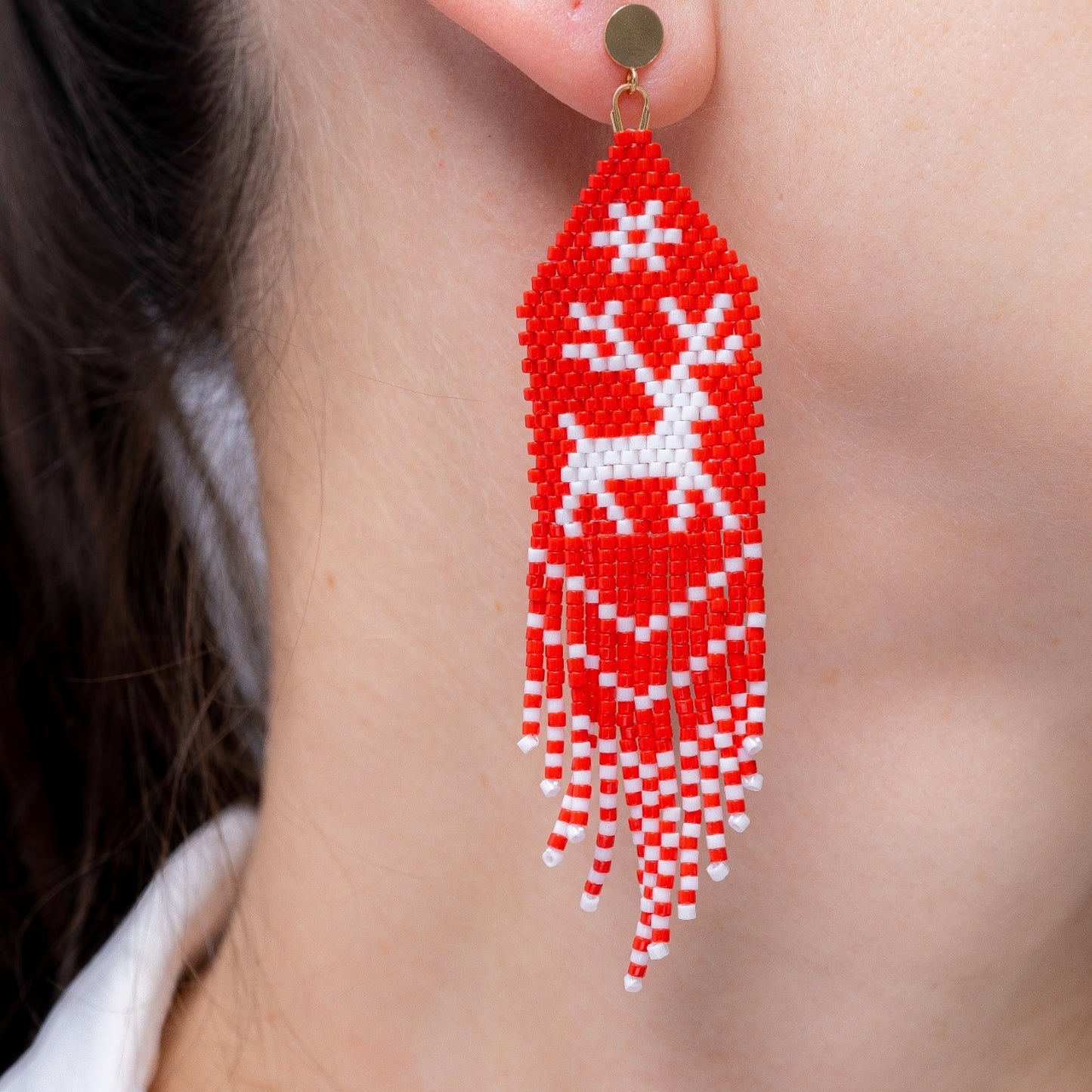 reindeer beaded Christmas earrings on a model