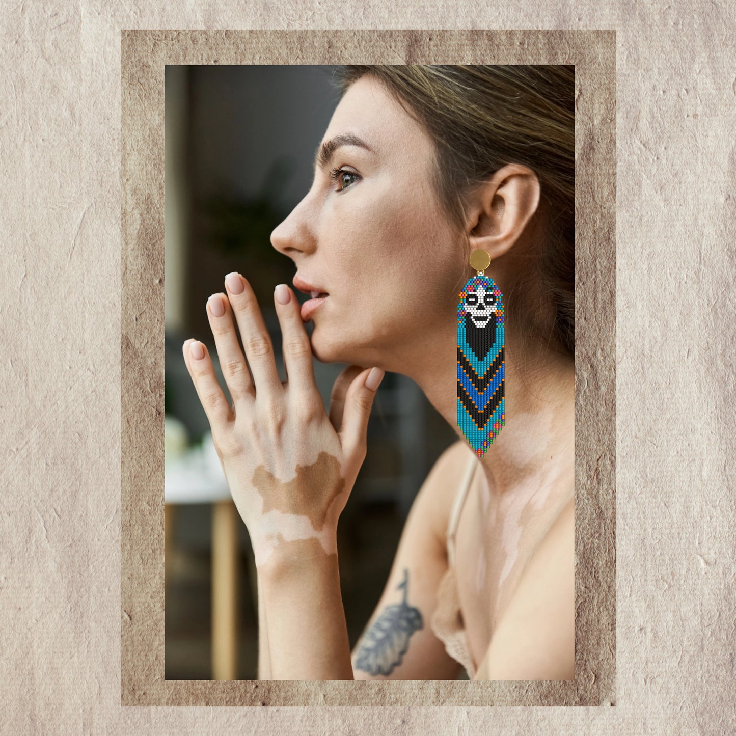 Woman wearing skull beaded earrings with a neutral background